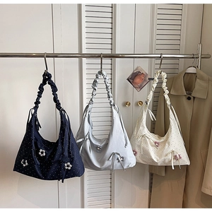 Detail view of floral polka dot tote bags with ribbon bows and ruffled shoulder straps