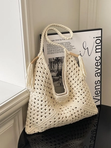 Handcrafted cream woven tote bag with fringe tassels and sturdy knit handles for women
