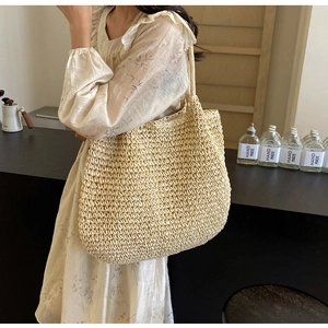 Detailed view of the large hand-woven straw tote bag with a natural texture finish