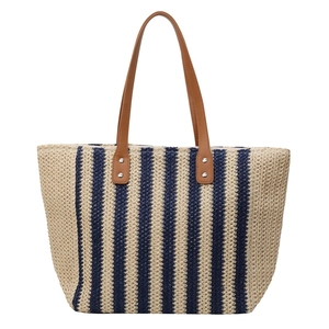 Large straw tote bag with navy blue and beige vertical stripes and brown PU leather handles
