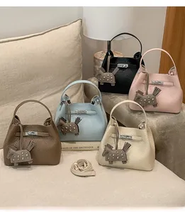 Litchi pattern leather bucket bags in five colors with horse charms and metal buckles