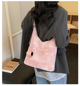 Detail of pink geometric pattern tote bag with matching coin purse on crossbody strap