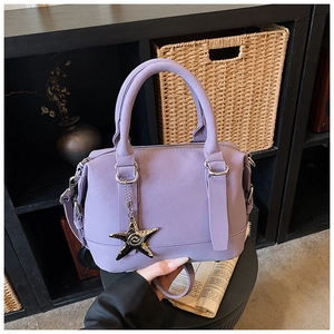 Detailed macro view of lavender leather bowling bag with silver hardware and starfish charm