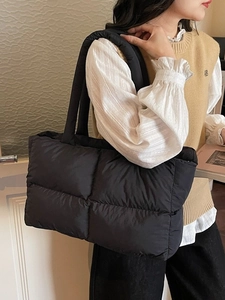 Quilted black puffer tote bag for women with spacious design and padded shoulder straps