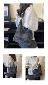 Macro detail of dark grey geometric patterned tote bag with textured knit fabric