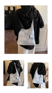 Detail of color-block tote bag with a small matching pouch shown in a home setting