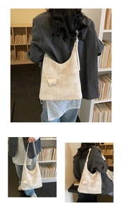 Chic beige jacquard hobo bag with mini coin purse shown in lifestyle bookshelf setting