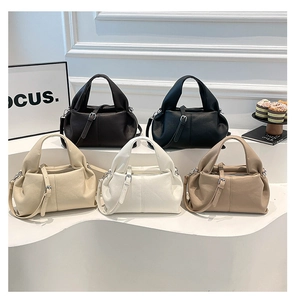 Detailed close-up of textured leather cloud-shaped handbags in five elegant colors
