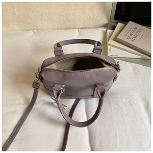 Top view of open mauve bowling bag showing spacious interior and golden zipper detail