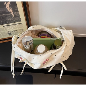 Internal view of a floral polka dot tote bag showing large storage capacity for cosmetics