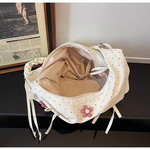 Internal view of floral tote bag showing spacious beige lining and secure zipper pocket