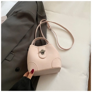 Close-up of light pink bucket bag with silver twist lock and smooth leather texture