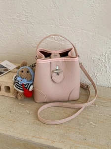 Pale pink lychee grain bucket bag with teddy bear pendant and adjustable strap