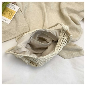Close-up of the internal zipper pocket and fabric lining of this woven beach shoulder bag