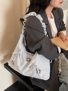 Light blue polka dot tote bag with bow detail and ruffled strap for daily casual style