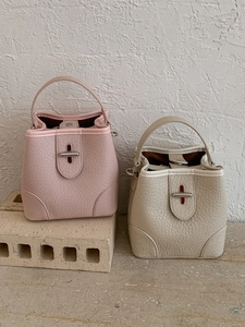 Litchi pattern bucket handbag in soft pink and cream beige with metal lock closure
