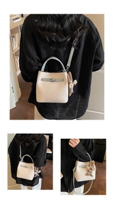 Detail of contrast bucket bag with silver twist lock and cute bunny charm accessory