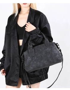 Detail view of charcoal gray vintage Boston bag with matte suede texture and metal hooks