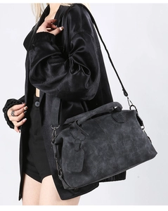 Close-up of a large dark grey matte crossbody bag with minimalist hardware and handles