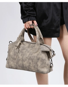 Detail of vintage boston bag with gray marble texture leather and double handles