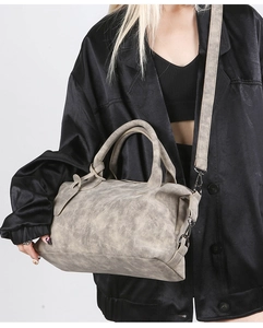 Detail showing the retro textured taupe leather Boston bag with dark metal hardware