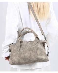 Detailed back view of grey retro Boston bag with adjustable strap on model