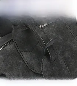Macro shot of fine stitching and suede leather texture on this black Boston shoulder bag