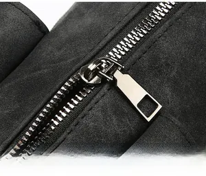 Close-up of smooth silver metal zipper on premium black matte textured handbag
