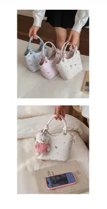 Detail of mini bucket bags with floral teddy bear print and woven top handles