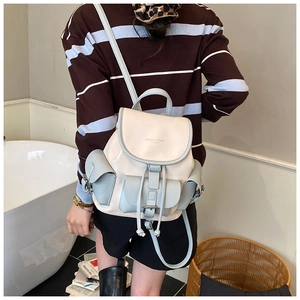 Detail of color-block backpack with adjustable straps shown on a female model