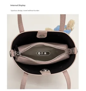 Pink lychee grain leather tote bag interior with inner pouch and teddy bear charm