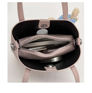 Top view of lychee leather bucket bag showing interior storage with magnetic closure