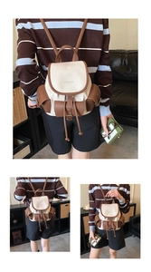 Detail of vintage beige and brown PU leather backpack with multiple pockets and drawstring