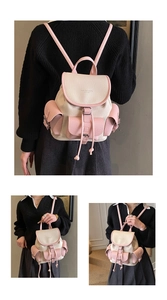 Detail of pink and beige faux leather backpack with litchi grain and drawstring closure