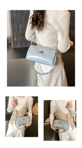 Detailansicht der hellblauen Umhängetasche aus Leder mit silbernem Drehverschluss und Kette