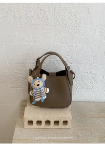 Retro bucket bag with litchi texture leather and a cute knitted bear charm on stone base