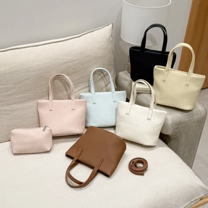 Detailed view of荔枝 texture on minimalist tote bags in various pastel and neutral colors