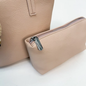 Detail of pink pebbled leather tote set with high-quality silver zipper hardware