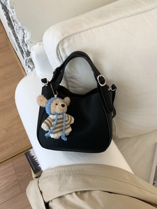 Vintage black lychee leather bucket bag with a cute bear plush keychain accessory