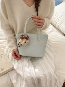 Light blue lychee grain leather bucket bag with a cute teddy bear plush pendant charm