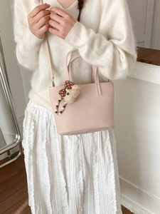 Light pink pebbled leather bucket bag with a cute bear charm for women's casual style