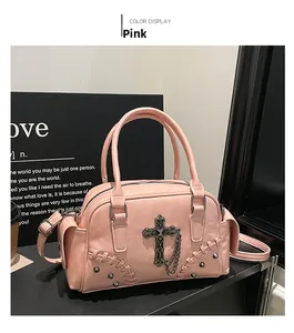 Détail du sac Boston rose avec croix métallique vintage, clous et coutures artisanales