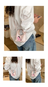 Detailed close-up of pink quilted mini crossbody bag with pony patch and thin strap