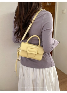 Elegante borsa a mano giallo tenue con fibbia quadrata minimalista sulla modella