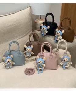 Detailed close-up of shell bags in six colors with leather texture and bear charms