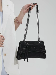 Black matte leather shoulder bag with metallic chain straps and stud details