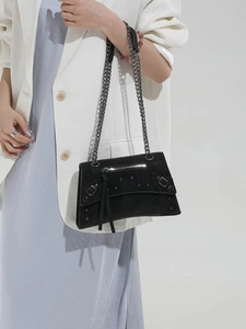 Chic black matte shoulder bag with silver studs and chain strap in classic biker style