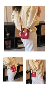 Detail view of red quilted crossbody bag with cute pony embroidery and shoulder strap