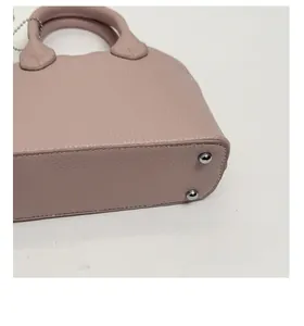 Detailed macro view of the bag's thickened base with metal feet for structural support