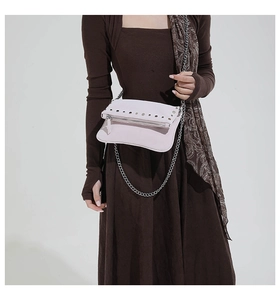 Détail du sac bandoulière vintage rose avec clous et chaîne en métal argenté